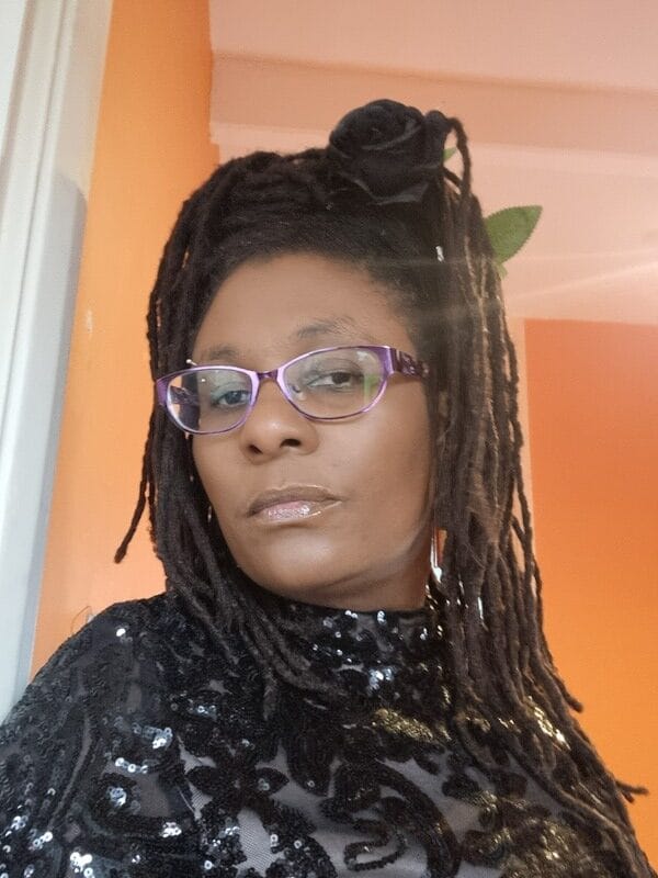 Photo of Andrea Knowles with an orange background